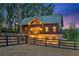 Elegant home featuring stone accents, complemented by mature trees and professional landscaping at 150 Trinity Farm Dr, Canton, GA 30115