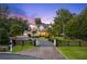 Beautiful home with a circular driveway, manicured lawn, and black fence at 150 Trinity Farm Dr, Canton, GA 30115