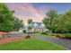 Exterior view of the house, garage, circle drive, and landscaped front yard at 150 Trinity Farm Dr, Canton, GA 30115