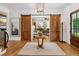 Wide foyer featuring wooden sliding doors, views into multiple rooms, and wood floors at 150 Trinity Farm Dr, Canton, GA 30115