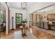 Foyer showcasing a dining room, chandelier, wooden door, and wood floors at 150 Trinity Farm Dr, Canton, GA 30115