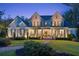 Stately two-story home showcases a lush lawn, inviting porch, and timeless facade at 150 Trinity Farm Dr, Canton, GA 30115