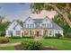 Stunning two-story home with white siding, shutters, manicured lawn, and inviting front porch at 150 Trinity Farm Dr, Canton, GA 30115