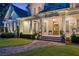 Charming facade features a covered porch, classic shutters, and manicured landscaping at 150 Trinity Farm Dr, Canton, GA 30115