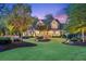 Well-lit two-story home boasts a landscaped front yard, a welcoming porch, and classic shutters at 150 Trinity Farm Dr, Canton, GA 30115