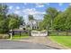 Gated property featuring a charming white farmhouse, well-manicured lawn, and mature trees at 150 Trinity Farm Dr, Canton, GA 30115