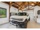 Spacious garage with epoxy floors, wood trusses, mini-split, and a Hummer EV at 150 Trinity Farm Dr, Canton, GA 30115