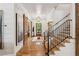 Spacious hallway with wood floors, staircase, barn door, and natural light at 150 Trinity Farm Dr, Canton, GA 30115
