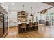 Open kitchen and dining area featuring a large island, modern cabinets and exposed wood beams at 150 Trinity Farm Dr, Canton, GA 30115