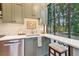 Well-lit kitchen featuring stone countertops, stainless steel appliances, and a breakfast bar with seating at 150 Trinity Farm Dr, Canton, GA 30115