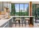Kitchen view with granite counters, bar stool seating and a large window to view outdoor scenery at 150 Trinity Farm Dr, Canton, GA 30115