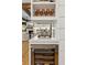 Elegant dining nook with wine cooler, glass shelving and views to the Gathering room beyond at 150 Trinity Farm Dr, Canton, GA 30115