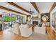 Stately living room with exposed beams, a white brick fireplace, and access to the patio at 150 Trinity Farm Dr, Canton, GA 30115