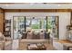 Open living space extends to outdoor area with pool view, featuring stylish seating and exposed beams at 150 Trinity Farm Dr, Canton, GA 30115