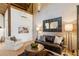 Bright living room with comfortable seating, wood floors, and a decorative mirror at 150 Trinity Farm Dr, Canton, GA 30115