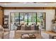 Open concept living room with seamless indoor-outdoor flow and a view of the backyard pool at 150 Trinity Farm Dr, Canton, GA 30115