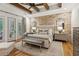 Spacious main bedroom with brick accent wall and exposed beam ceiling at 150 Trinity Farm Dr, Canton, GA 30115