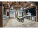 Covered outdoor kitchen with grill, pizza oven, dining table, and mounted TVs, perfect for entertaining at 150 Trinity Farm Dr, Canton, GA 30115
