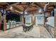 Outdoor kitchen with dining space features stainless steel appliances, pizza oven, and TVs for entertainment at 150 Trinity Farm Dr, Canton, GA 30115