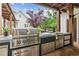 Covered outdoor kitchen featuring stainless steel appliances and ample counter space at 150 Trinity Farm Dr, Canton, GA 30115