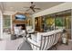 Cozy outdoor living with a brick fireplace, ceiling fan, and plush seating at 150 Trinity Farm Dr, Canton, GA 30115