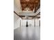 Recreation room showcasing high ceilings with exposed wood beams and elegant lighting fixtures above the basketball court at 150 Trinity Farm Dr, Canton, GA 30115