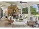 Inviting screened porch with brick fireplace, comfortable seating, and backyard views at 150 Trinity Farm Dr, Canton, GA 30115