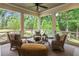 Relaxing screened porch with comfortable seating and serene wooded views at 150 Trinity Farm Dr, Canton, GA 30115