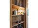 Built in shelving with books, wine storage, vases, and a lamp with wood trim and recessed lighting at 150 Trinity Farm Dr, Canton, GA 30115