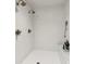 Bright, all-white shower featuring dual shower heads, mosaic tile floor, and a built-in shelf for toiletries at 150 Trinity Farm Dr, Canton, GA 30115