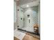 Beautiful walk-in shower with decorative tile, glass door, and built-in niche at 150 Trinity Farm Dr, Canton, GA 30115