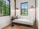 Bright sitting area features shiplap walls, black-framed windows, and a comfortable chaise lounge with views of the home's exterior at 150 Trinity Farm Dr, Canton, GA 30115