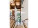 Open staircase leading to a landing with views to the kitchen and outdoor patio with exposed beams at 150 Trinity Farm Dr, Canton, GA 30115