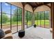 Bright sunroom with black-framed windows offers backyard views; a stylish space to enjoy the natural surroundings and tranquility at 150 Trinity Farm Dr, Canton, GA 30115