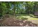 Grassy backyard featuring lush greenery, mature trees, and ample space for entertaining at 1829 Goddard Se St, Atlanta, GA 30315