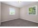 Bedroom with neutral walls and carpet, flooded with natural light from two windows at 1829 Goddard Se St, Atlanta, GA 30315