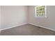 Bright bedroom features neutral paint, carpet flooring, and a window with exterior views at 1829 Goddard Se St, Atlanta, GA 30315