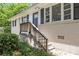 Close up on the home's front entrance, featuring a black door, white trim, and a wooden porch at 1829 Goddard Se St, Atlanta, GA 30315