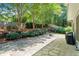 Landscaped backyard with stone patio and lush greenery providing a private outdoor retreat at 1241 Newbridge Trce, Brookhaven, GA 30319
