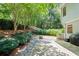 A spacious backyard featuring a stone patio, fire pit, and lush landscaping that offers privacy at 1241 Newbridge Trce, Brookhaven, GA 30319