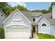 Charming two-story home with attached garage, a manicured lawn, and beautiful architectural detailing at 1241 Newbridge Trce, Brookhaven, GA 30319