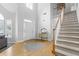 A grand foyer featuring hardwood floors, high ceilings, and a staircase leading to the upper level at 1241 Newbridge Trce, Brookhaven, GA 30319