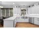 Modern white kitchen with stainless steel appliances, hardwood floors and eat in breakfast area at 1241 Newbridge Trce, Brookhaven, GA 30319