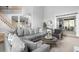 Bright living room features a large grey sectional, high ceilings, and lots of natural light at 1241 Newbridge Trce, Brookhaven, GA 30319