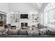 Bright living room featuring a fireplace, built-in shelves, and a view of the lush backyard at 1241 Newbridge Trce, Brookhaven, GA 30319