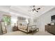 Spacious main bedroom features a tray ceiling, ceiling fan, and two windows overlooking the yard at 1241 Newbridge Trce, Brookhaven, GA 30319