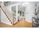 Staircase leading to the upper level, with hardwood floors and a view of the living room at 1241 Newbridge Trce, Brookhaven, GA 30319