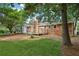 Spacious backyard with lush green lawn, brick house, and wooden deck, perfect for outdoor activities at 1869 Hebron Hills Dr, Tucker, GA 30084