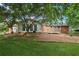 Picturesque backyard featuring well-maintained lawn, brick home and inviting outdoor space, ideal for relaxation at 1869 Hebron Hills Dr, Tucker, GA 30084