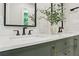 Elegant bathroom featuring a double sink vanity with olive green cabinets and quartz countertops at 1869 Hebron Hills Dr, Tucker, GA 30084